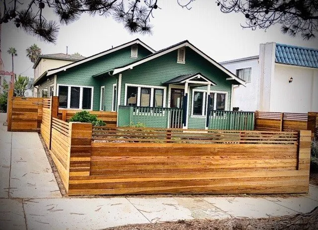 Green-Painted Residential House and Wood Staining